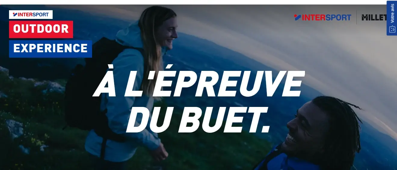 Le haut de la page Outdoor Experience sur intersport.fr : « À l'épreuve du Buet. » en grandes capitales sur la photographie de deux randonneurs, sous les logos Intersport et Millet.